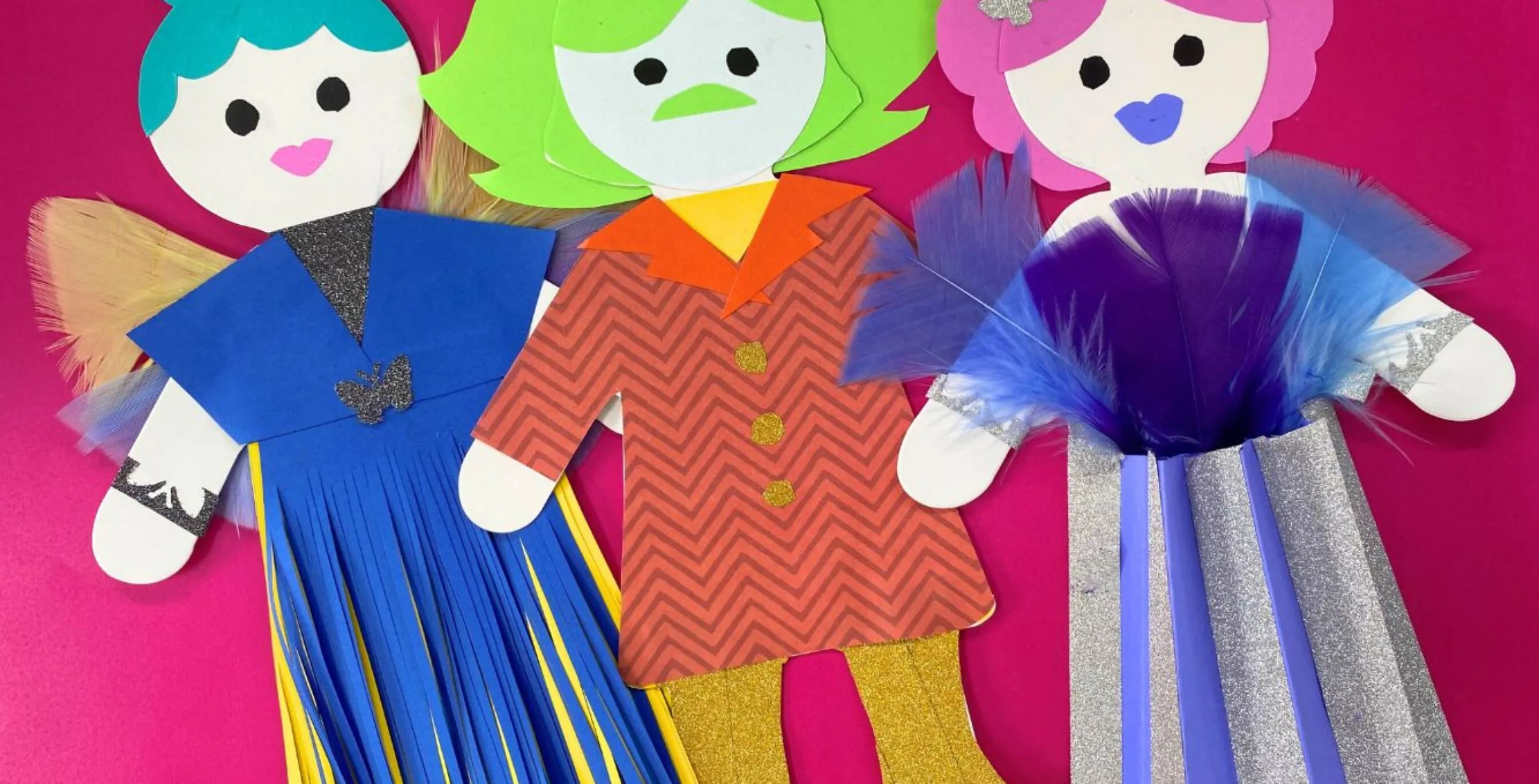 Three vibrant dolls are adorned with paper clothing. Additional details and texture are created with glitter, tape, feathers and pleats.