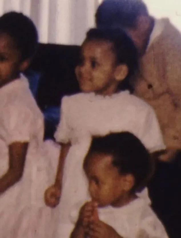 three young children are seen dancing in a dimly lit family room in the 1960s.